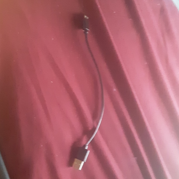 A blue light up paw charging bank with charger - Picture 3 of 5